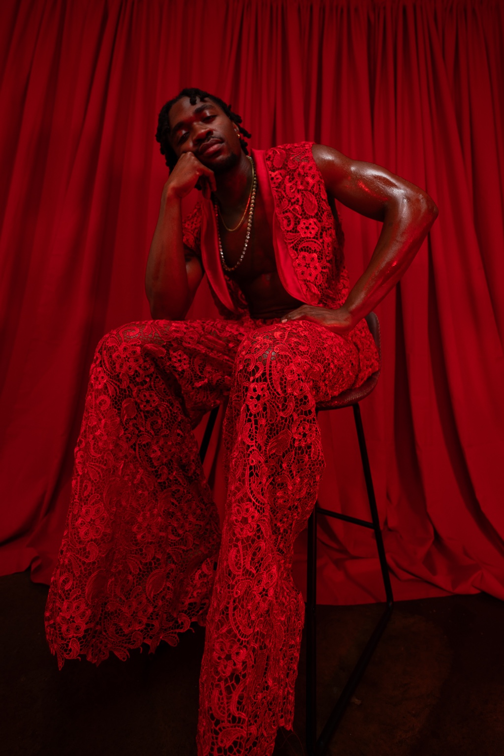 Enow Otto Jr wearing a red lace fashion look